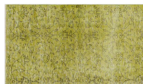 Load image 1 in gallery view. Chartreuse and white distressed rug with a faded traditional floral medallion pattern.