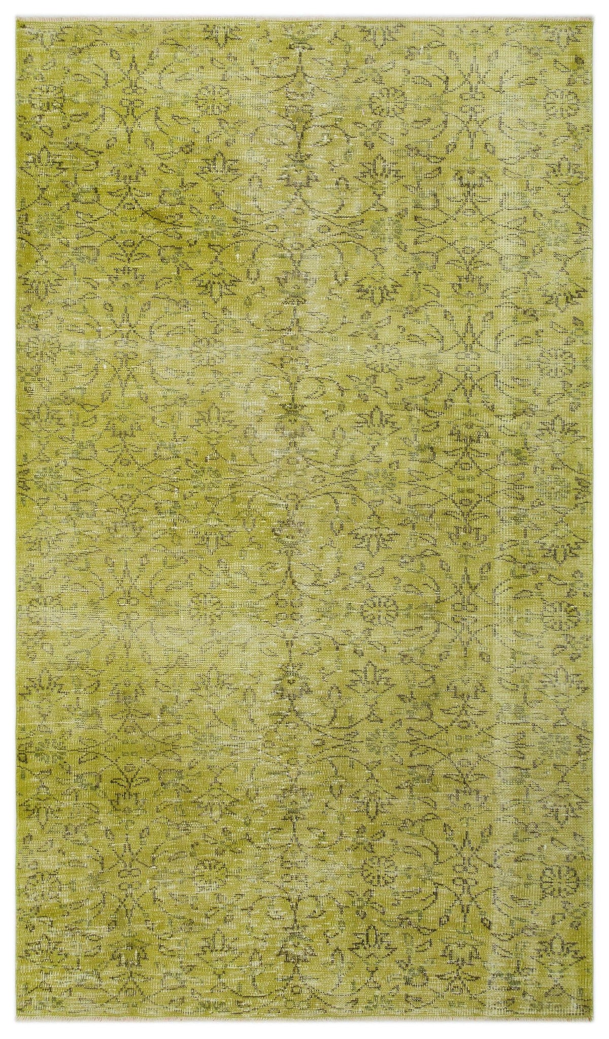 Chartreuse distressed rug with a faded dark green floral medallion pattern.