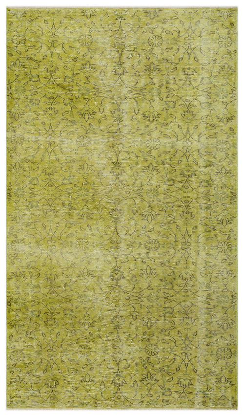 Load image 1 in gallery view. Chartreuse distressed rug with a faded dark green floral medallion pattern.