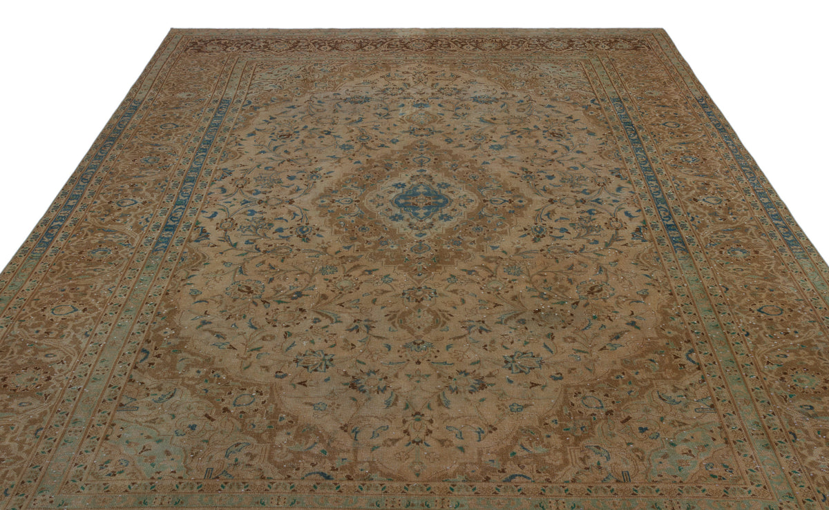 Tan and blue traditional Persian-style rug with a central floral medallion and intricate border on a white background.