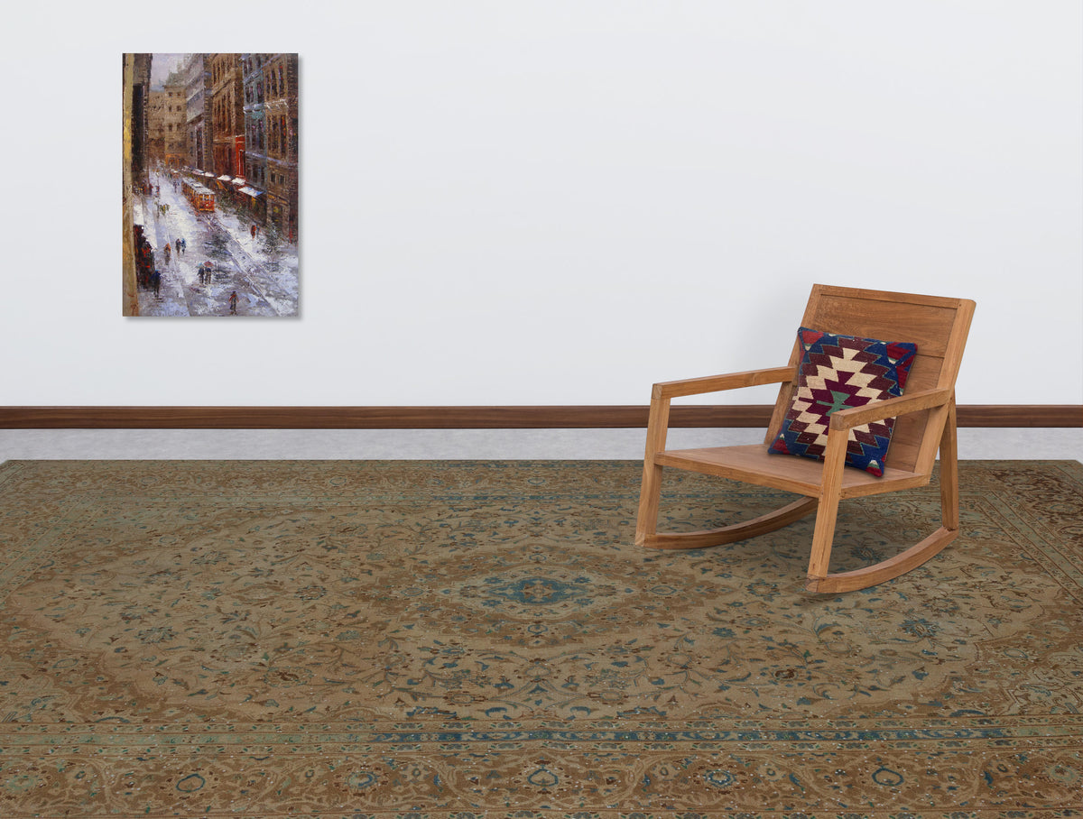 Tan and blue traditional floral medallion rug in a room with a wooden rocking chair and wall art.