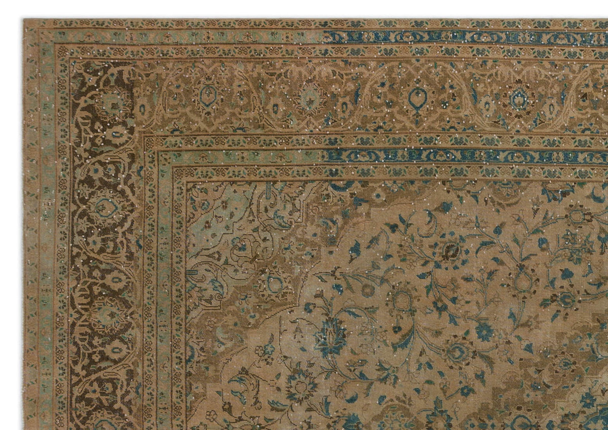 Tan and blue traditional rug with a distressed floral medallion pattern and intricate border.