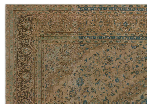 Load image 1 in gallery view. Tan and blue traditional rug with a distressed floral medallion pattern and intricate border.