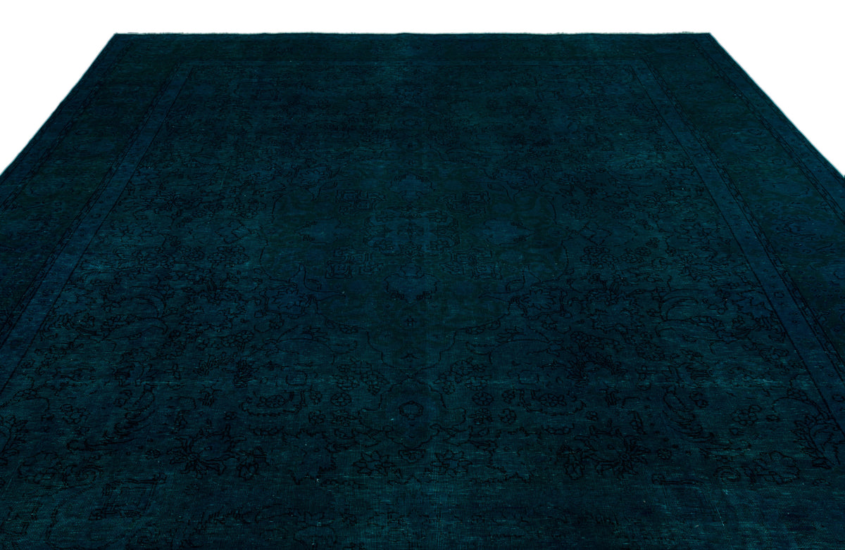 Dark teal monochromatic rug with a subtle, tone-on-tone traditional floral medallion pattern.