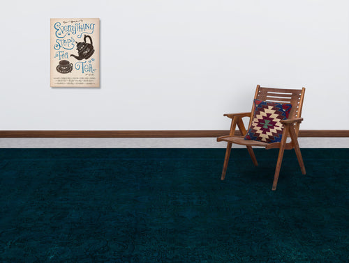 Load image 1 in gallery view. Dark teal rug with a subtle tonal floral pattern, styled in a room with a wooden chair and wall art.