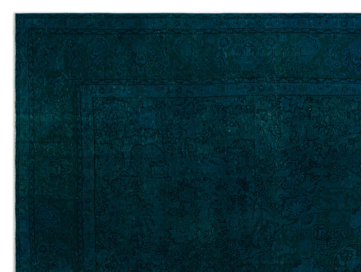 Dark teal monochromatic rug with a traditional floral medallion pattern and a detailed border.