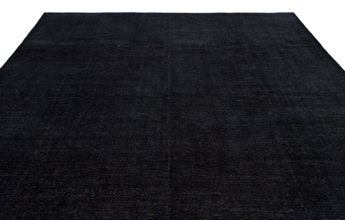 Load image 1 in gallery view. Solid black rug with a subtle, distressed vintage texture on a white background.
