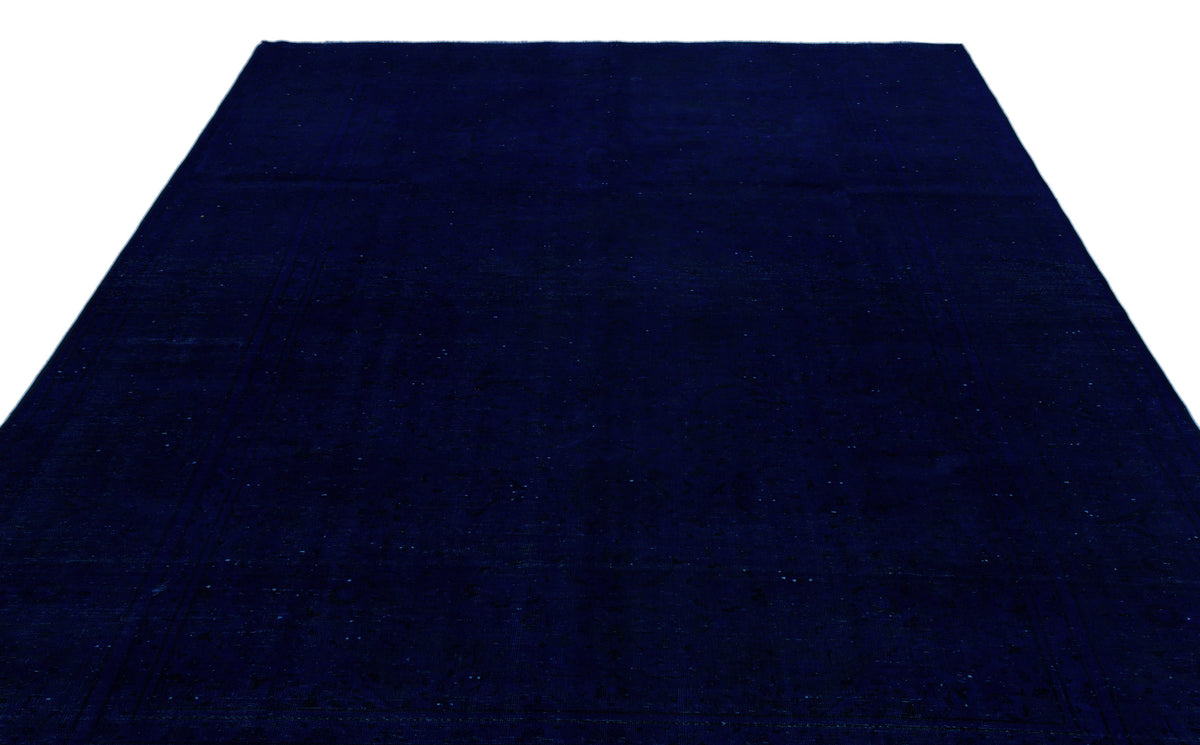 Solid navy blue rug with a subtle, tonal distressed border pattern on a white background.