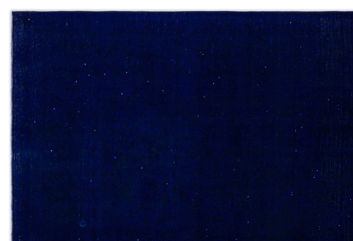 Solid deep navy blue rug with a subtle, distressed texture and faint, scattered white flecks.