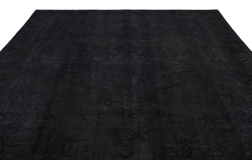 Load image 1 in gallery view. Monochromatic black rug with a subtle, tone-on-tone traditional medallion pattern and a decorative border.