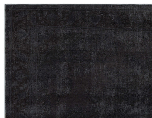 Load image 1 in gallery view. Monochromatic black rug with a subtle, distressed traditional floral medallion pattern and a wide border.