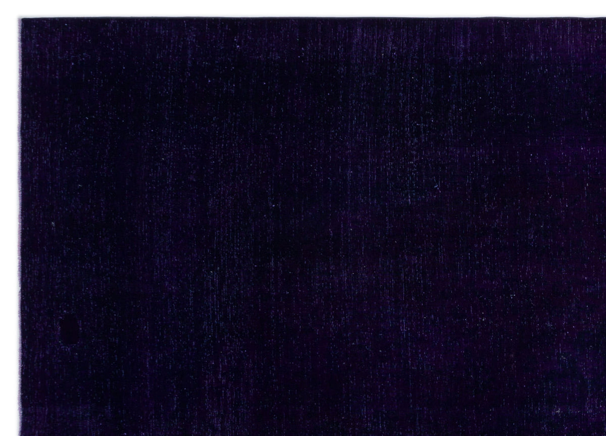 Solid deep purple rug with a subtle, uniform vertical texture.
