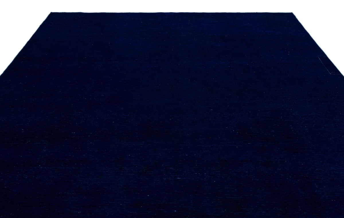 Solid deep navy blue area rug with a uniform, minimalist texture.