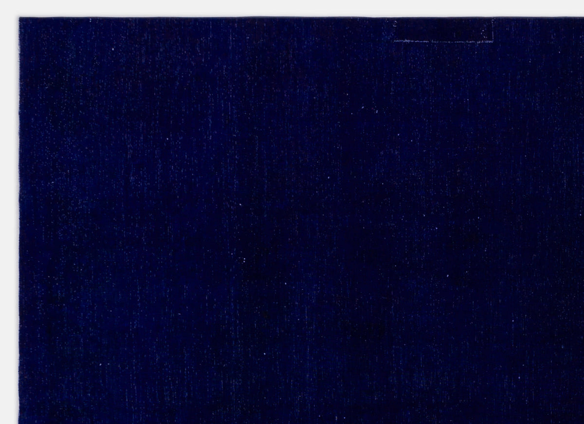 Solid deep navy blue rug with a subtle, uniform textured weave.