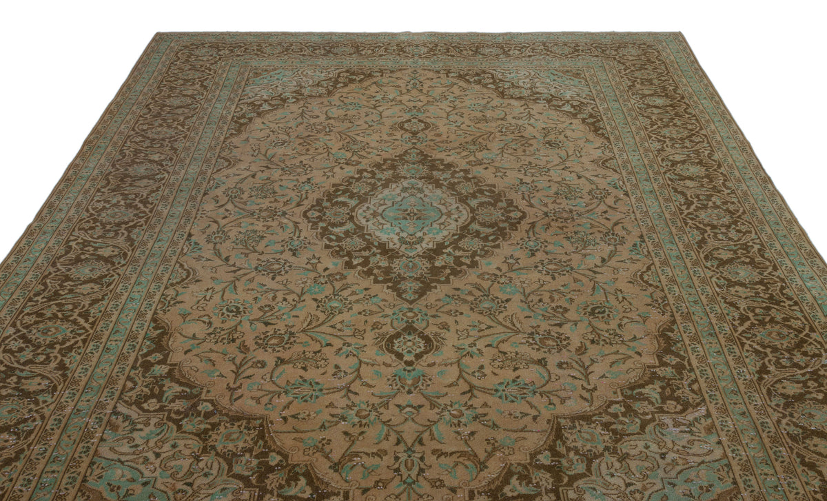 Brown and teal traditional Persian-style rug with a central floral medallion and intricate vine border.