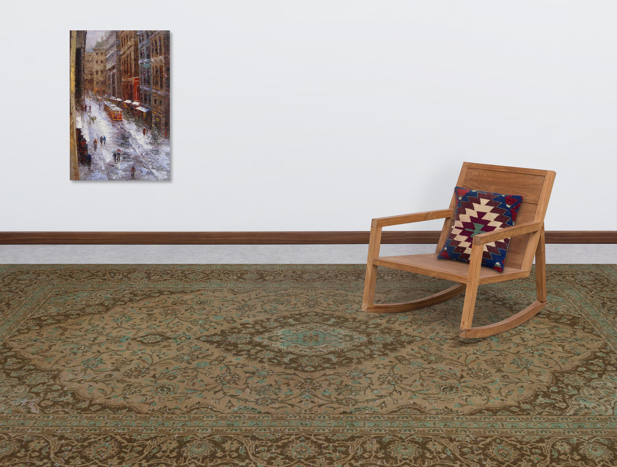 Brown and sage green traditional medallion rug in a room with a wooden rocking chair and wall art.
