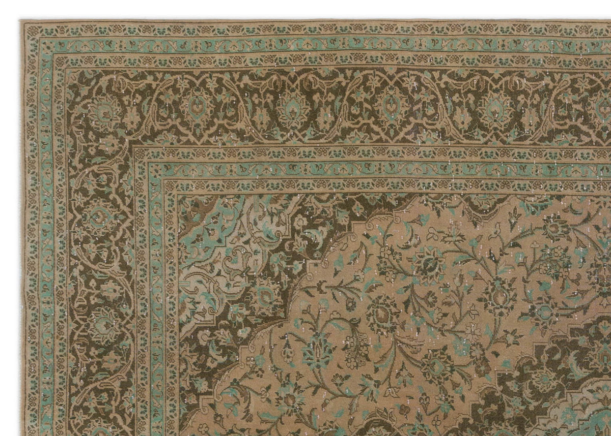 Tan and dark brown traditional rug with a distressed floral medallion pattern and teal accents.