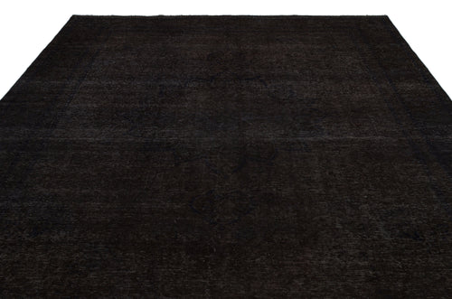 Load image 1 in gallery view. Solid black rug with a subtle, tonal distressed medallion pattern on a white background.