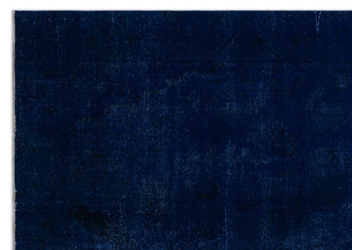 Load image 1 in gallery view. Solid deep navy blue rug with a subtle, distressed tonal medallion pattern.