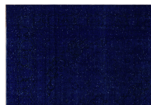 Load image 1 in gallery view. Deep navy blue rug with a subtle, distressed tonal medallion pattern and white flecked texture.