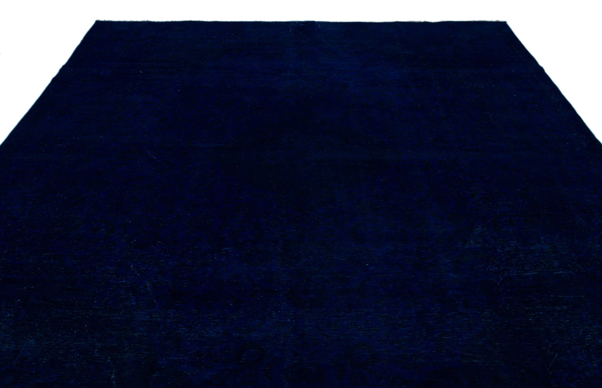 Solid deep navy blue rug with a subtle, tonal distressed pattern on a white background.