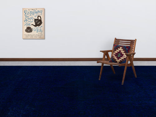 Load image 1 in gallery view. Solid deep blue rug in a room with a wooden chair and wall art.