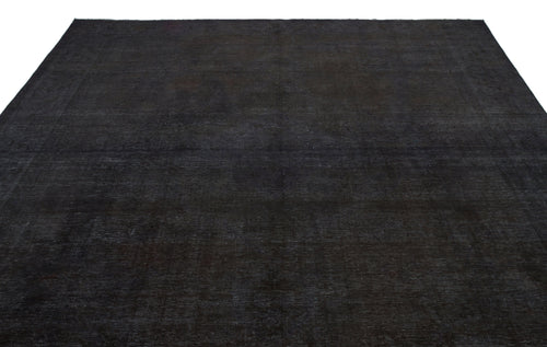 Load image 1 in gallery view. Solid black overdyed vintage rug with a subtle, distressed texture on a white background.