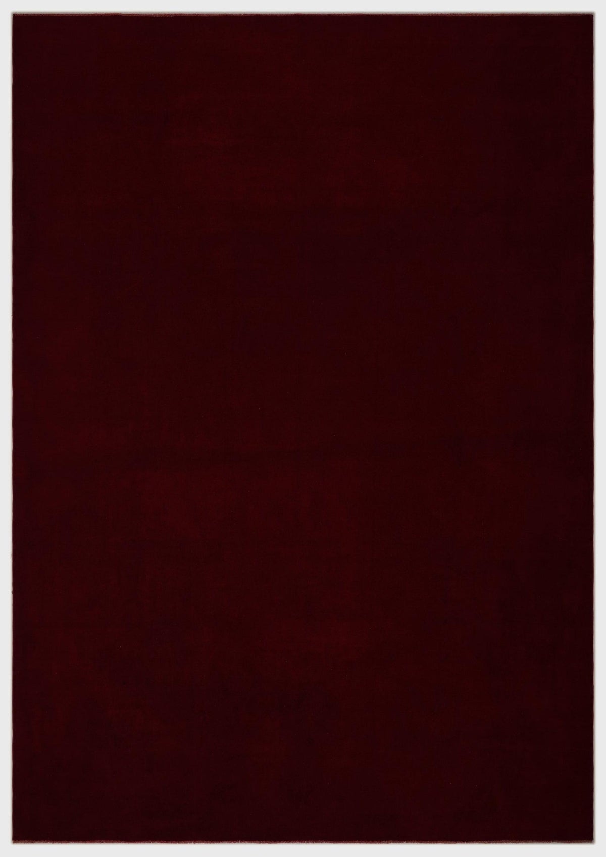 Solid deep burgundy rug with a uniform texture on a white background.