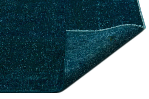 Load image 1 in gallery view. Deep teal distressed rug with a white speckled texture and a folded corner revealing the woven backing.