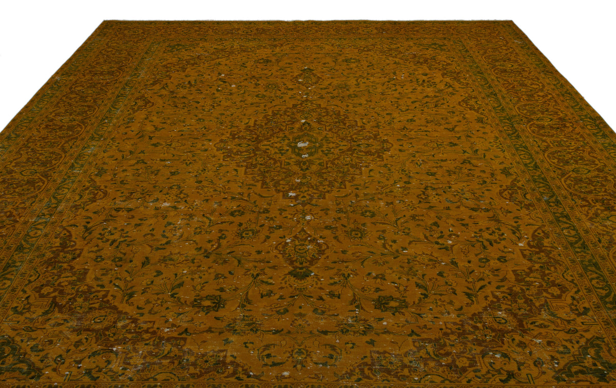 Mustard yellow traditional rug with a central floral medallion, intricate border, and distressed finish.