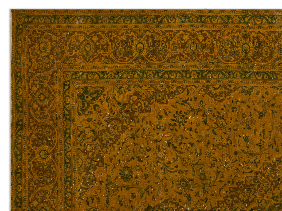 Mustard yellow and dark green traditional rug with an intricate floral border and central vine pattern.