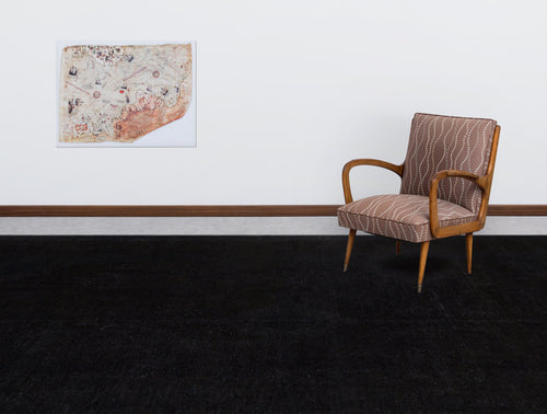 Load image 1 in gallery view. Solid black rug in a room with a patterned armchair and a vintage map wall art.