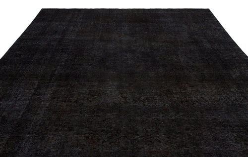 Load image 1 in gallery view. Solid black rug with a subtle, distressed traditional medallion pattern on a white background.