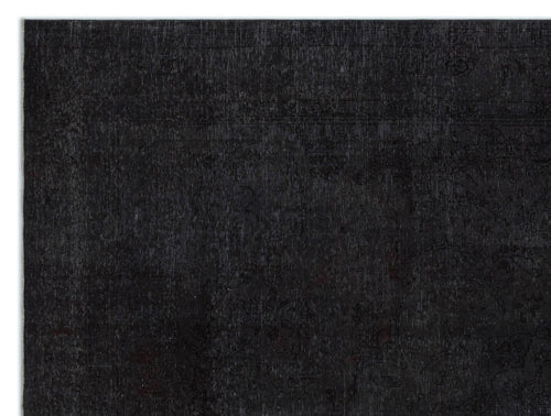 Load image 1 in gallery view. Solid black rug with a subtle, tone-on-tone distressed traditional floral pattern.