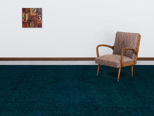 Load image 1 in gallery view. Solid dark teal rug with a subtle distressed texture, styled in a room with a mid-century armchair and wall clock.