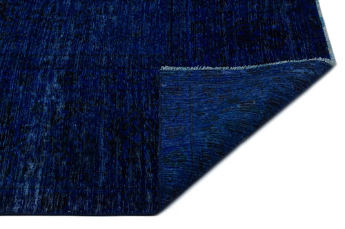 Load image 1 in gallery view. Deep blue distressed rug with a subtle vintage pattern and a folded corner showing the underside texture.
