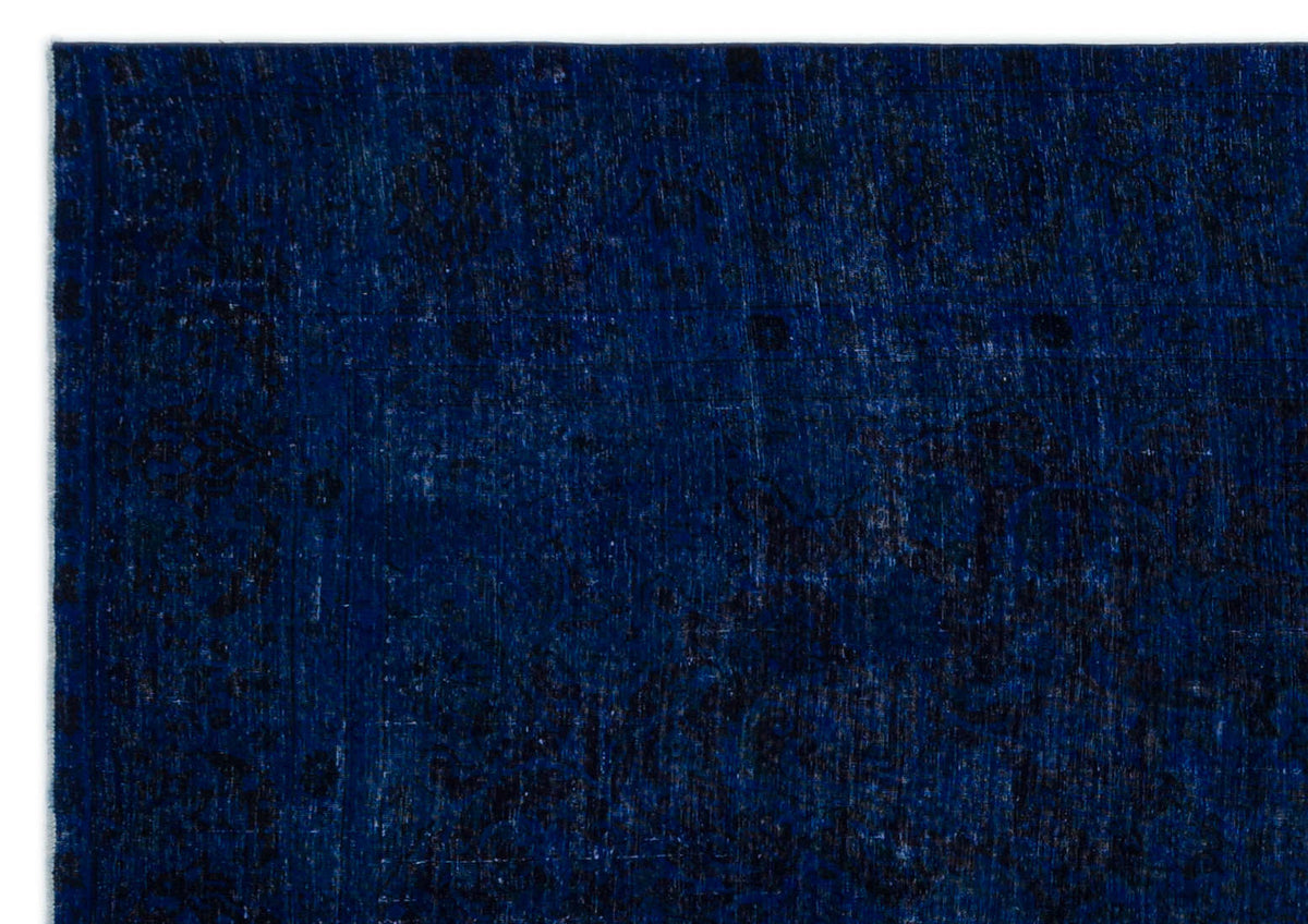 Deep navy blue rug with a distressed, tonal traditional medallion pattern.