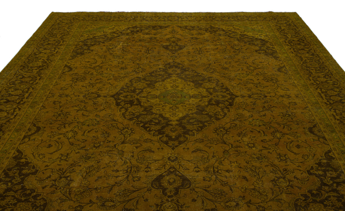 Olive green and dark brown traditional rug with a central floral medallion and intricate vine-scroll border.