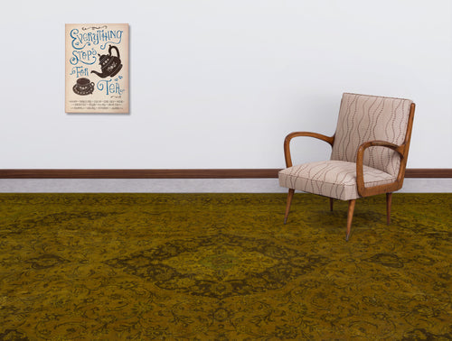 Load image 1 in gallery view. Olive green traditional rug with a dark floral medallion pattern, styled in a room with a patterned armchair.