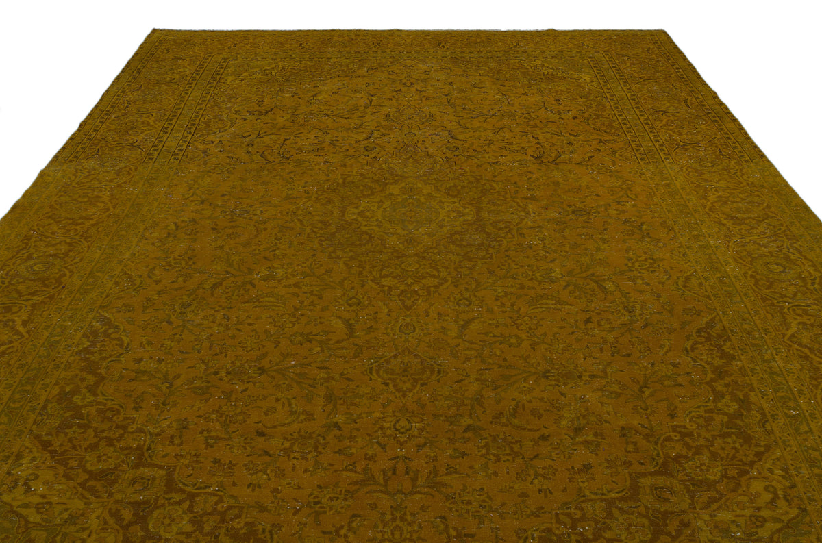 Mustard yellow traditional rug with a tonal floral medallion pattern and intricate border on a white background.