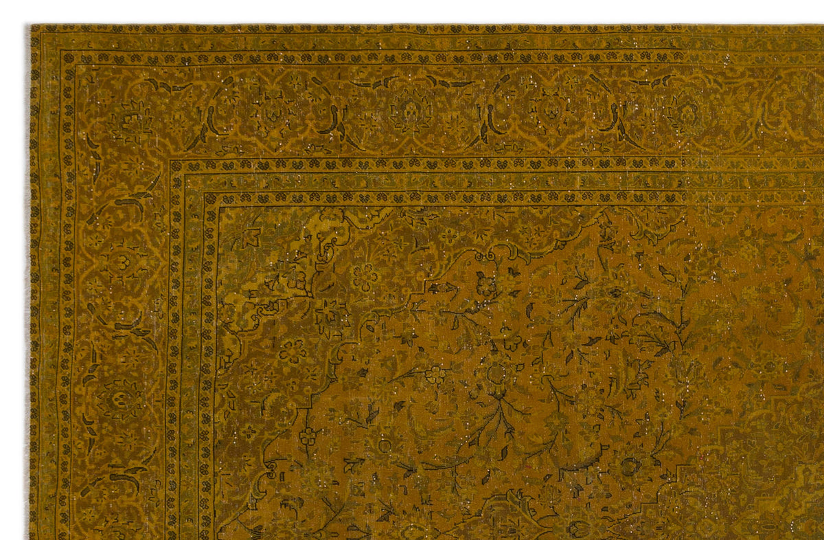 Mustard yellow distressed rug with a traditional floral medallion pattern and a detailed border.