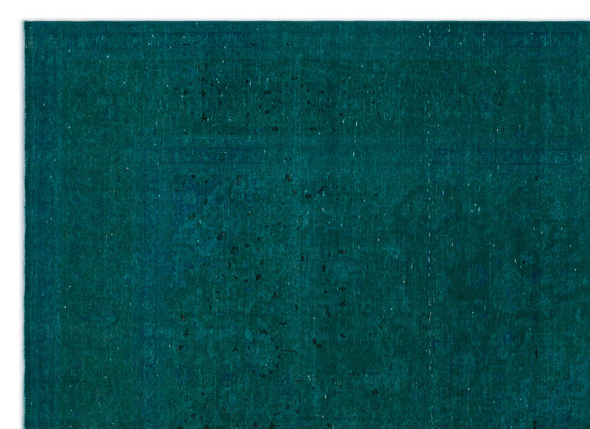 Deep teal rug with a subtle, distressed traditional medallion pattern and worn texture.
