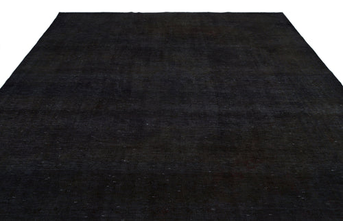 Load image 1 in gallery view. Solid black rug with a subtle, distressed texture and faint, scattered white flecks on a white background.