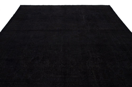 Load image 1 in gallery view. Solid black rug with a subtle, tonal traditional medallion pattern on a white background.