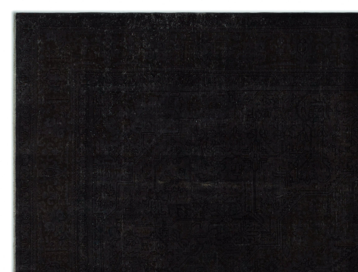 Black monochromatic rug with a subtle, distressed traditional Persian-style pattern and a wide border.