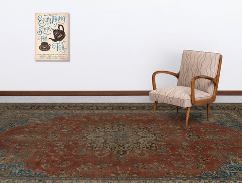 Load image 1 in gallery view. Rust and blue traditional medallion rug in a living room with a patterned armchair and tea-themed wall art.