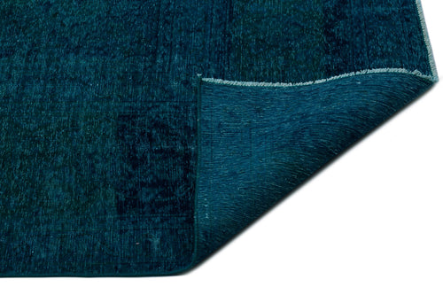 Load image 1 in gallery view. Deep teal distressed rug with a folded corner revealing the woven backing, isolated on a white background.