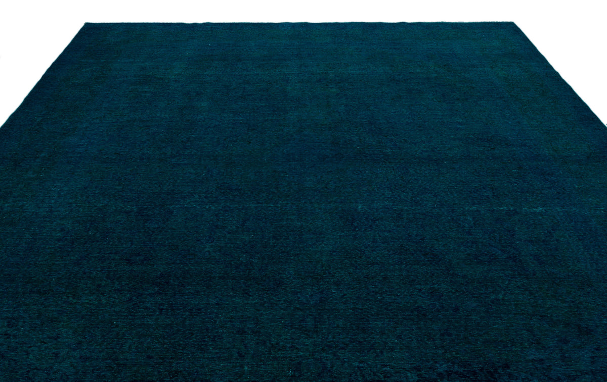 Solid deep teal rug with a subtle, distressed texture on a white background.