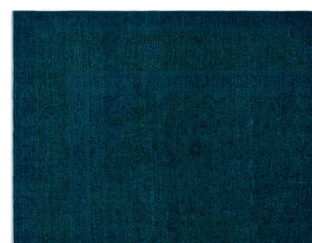 Deep teal monochromatic rug with a subtle, tone-on-tone traditional medallion pattern.