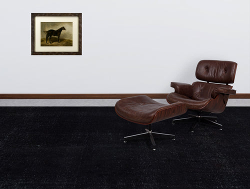 Load image 1 in gallery view. Solid black distressed-texture rug in a room with a brown leather lounge chair and a framed horse print.